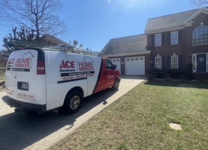 A Ace Hardware Home Services truck parked outside a home.